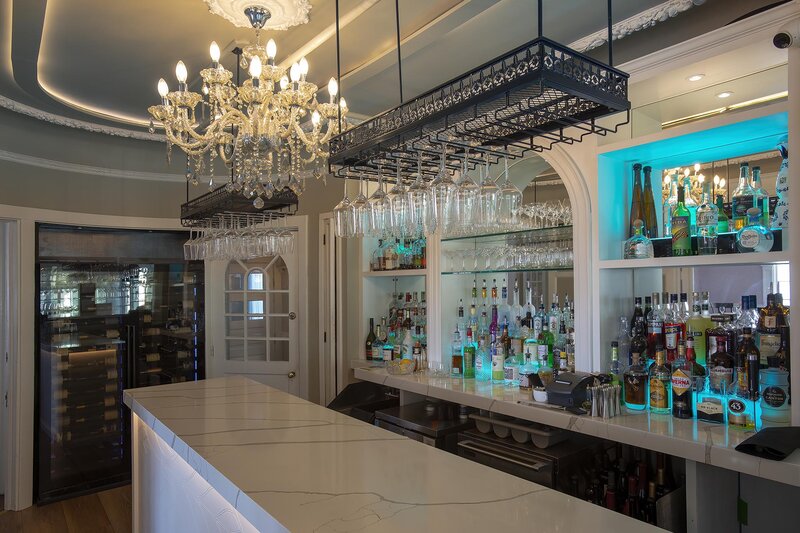 Bar area with stocked bar and wine case