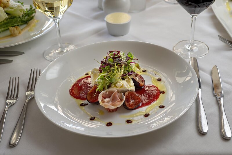 Burrata, Prosciutto, Marinated Figs, Arugula, Saba appetizer