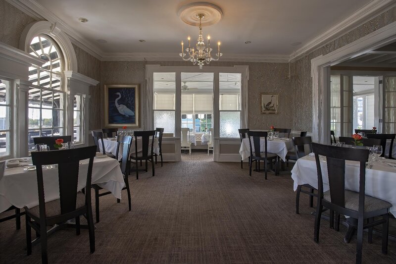 Dining room with multiple set tables and chandelier